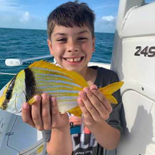 An exotic tropical fish this young man caught