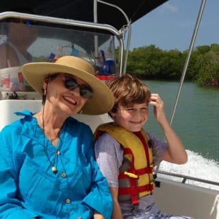 Lady and her grandson enjoying a boat ride